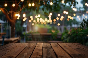 Front wooden plank table against a bright blurred cafe background with glowing street lanterns in...