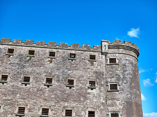 Old celtic castle tower and a house. Ancient Irish architecture background
