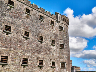 Fototapeta na wymiar Old celtic castle tower and a house. Ancient Irish architecture background
