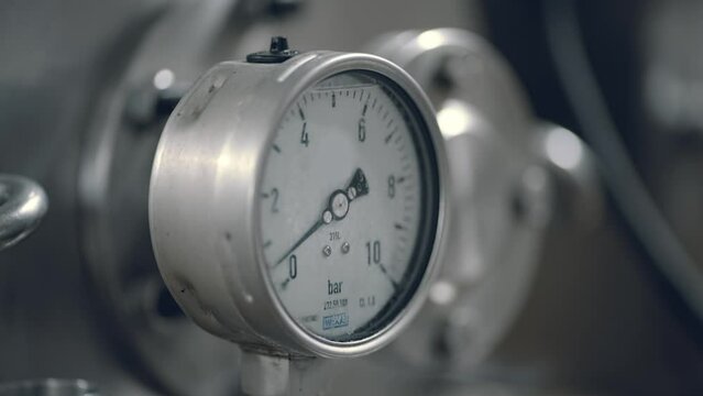 Close Up Of Pressure Measuring Gauge On Milk Processing Equipment. Pressure Gauge Measuring Applied Force Of Milk Liquid On Metal Tank. Pressure Measuring Manometer Gauge. Dairy Food Factory
