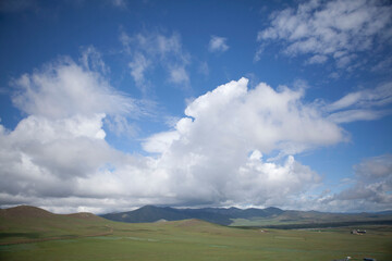 Rural Mongolia, landscape of green hills and blue sky with clouds