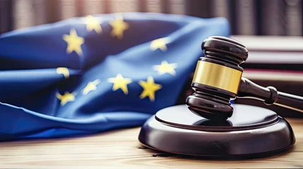 Fotobehang Asserting the principles of justice and unity, our image features a judge's gavel alongside the European Union flag on a dignified wooden table, leaving space for your legal narrative © pvl0707