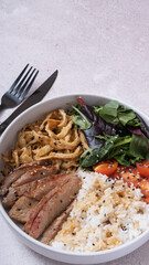 Bowl with rice, veal and vegetables angle view. Balanced nutrition concept.