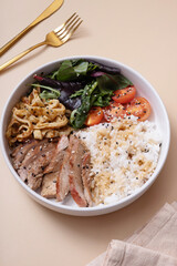 Bowl with rice, veal and vegetables top view. Balanced nutrition concept.