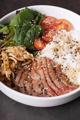 Close up bowl with rice, veal and vegetables. Balanced nutrition concept