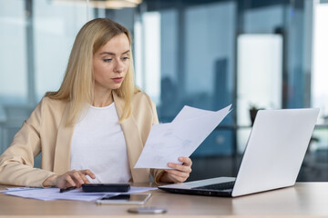 Professional woman working at her desk in modern office