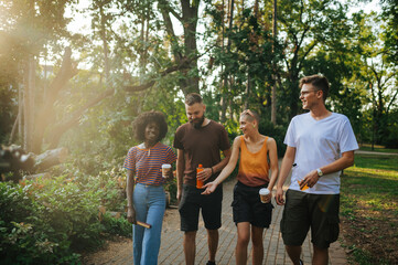 Young people talking in park and enjoying spending time together.