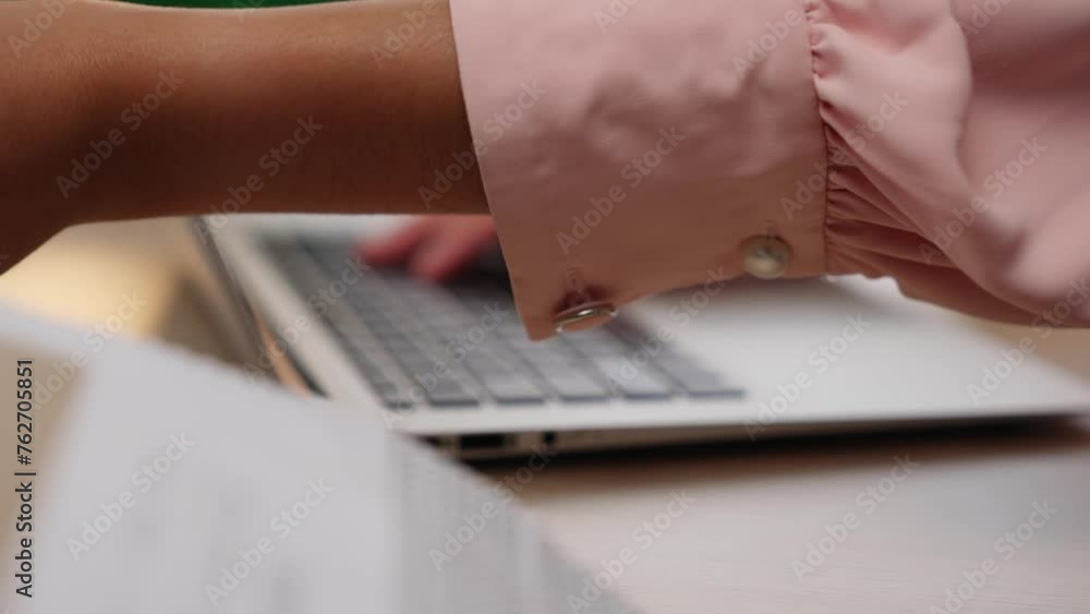 Poster slow motion closeup hand using laptop on workspace table on blurred background of colleagues or cowo