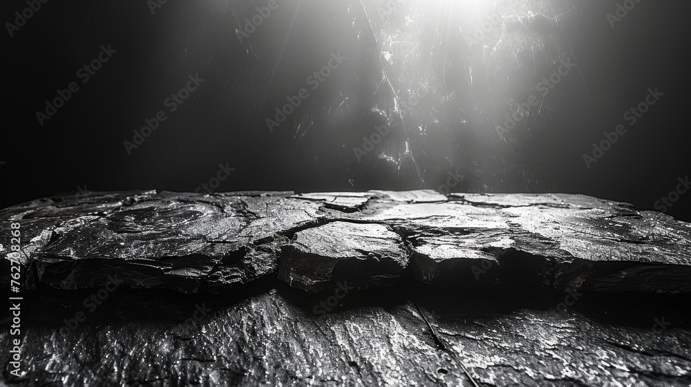 Aufkleber a monochromatic image portrays a rock illuminated by a light source at its peak, casting a beam of r