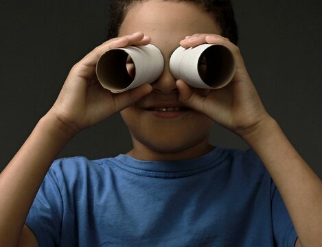 boy looking through toy binoculars toilet paper roll with people stock image stock photo