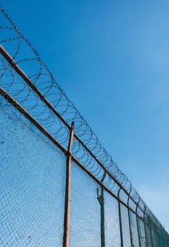 High security fence with barbed wire on border