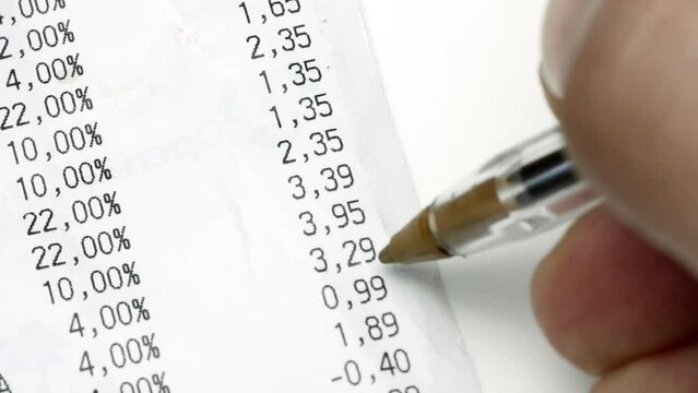 Closeup hands scrolling and checking receipt or bill.