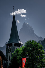 Steeple of St Mauritius parish church in Zermatt with Matterhorn in background in Switzerland.