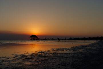 Sunset silhouette view of pier or hut in holbox quintana roo mexico