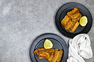 grilled Ray or skate filet decorated with slice of lemon