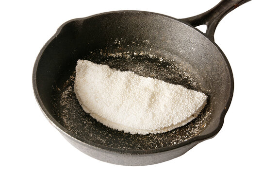 Tapioca Pancake inside a steel black skillet clean white background front view
