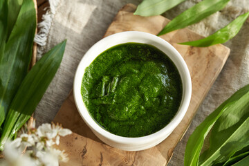 Pesto made of wild garlic or ramson leaves in a white bowl