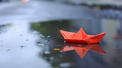 Paper boat in a puddle representing flood risk