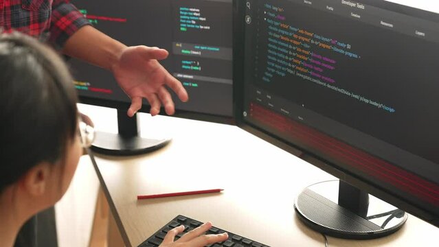 Slow motion back end or software developer manager supervising his team on new application program development on debugging and solving complex code algorithms on monitor. Burgeoning