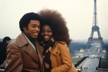 Tuinposter Black couple smiling at Eiffel Tower in Paris in 1970s © blvdone