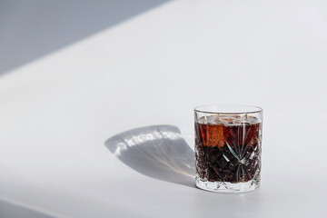 Whiskey cola cocktail with strong alcohol and ice in highball glass