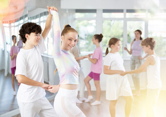 Pair of teen girl and guy enjoying of jive dance in choreo class. Exciting hobby, active lifestyle, passion for dancing and choreography