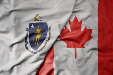 big waving realistic national colorful flag of massachusetts state and national flag of canada .