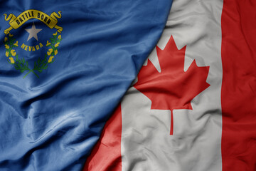 big waving realistic national colorful flag of nevada state and national flag of canada .