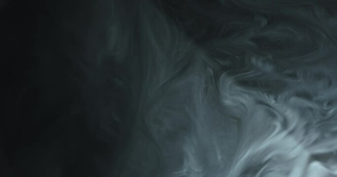 Smoke Drifting And Swirling In Darkness