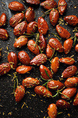 Roasted rosemary almonds  on a black background, close up view - 762763285