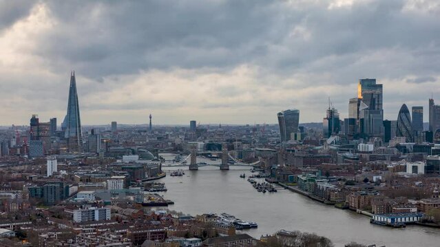 Panoramic day to night time lapse view of the skyline of London with City, Tower Bridge and skyscrapers, with cloudy winter sky