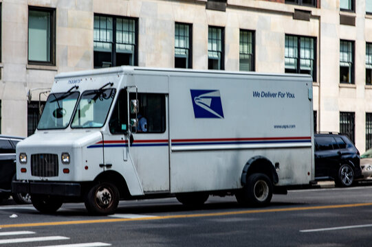 New York, USA; June 4, 2023: The typical mail and postal truck driving through Manhattan, in the heart of the Big Apple in the city of New York in the United States of America.