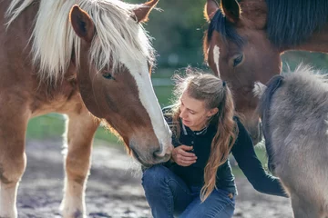 Foto op Plexiglas Friendship between a woman and her horses: Random horsemanship paddock scene © Annabell Gsödl