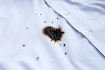 Dirty coffee stains on white clothes