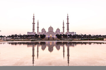 Evening view of Sheikh Zayed Grand Mosque in Abu Dhabi reflecting in a water, United Arab Emirates.