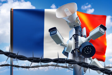Cameras near french flag. Barbed wire is metaphor for state border. France banner under blue sky. Concept of video surveillance system on border with France. CCTV cameras to limit unauthorized entry - obrazy, fototapety, plakaty