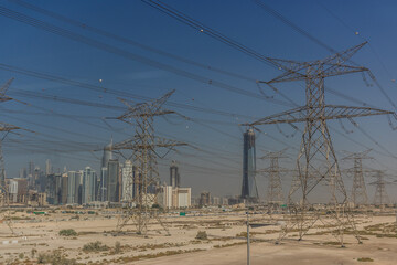 Pylons of high voltage electric transmission lines in Dubai, United Arab Emirates. - 762785604
