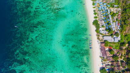 Long beach at Koh Phi Phi island, Krabi, Thailand. Tropical paradise white sand beach with turquoise waters of Andaman sea, aerial view. 