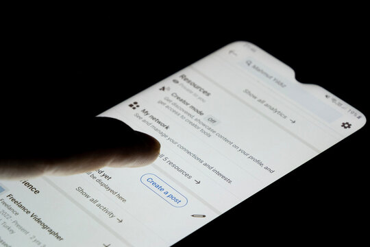 LinkedIn create a post button, smartphone screen with a black background, using LinkedIn app on android phone, sharing your thoughts: Istanbul, Turkey - 12.03.24