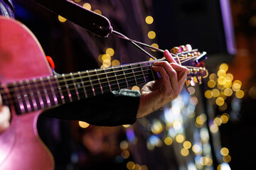 Musicians playing acoustic guitar, close up.