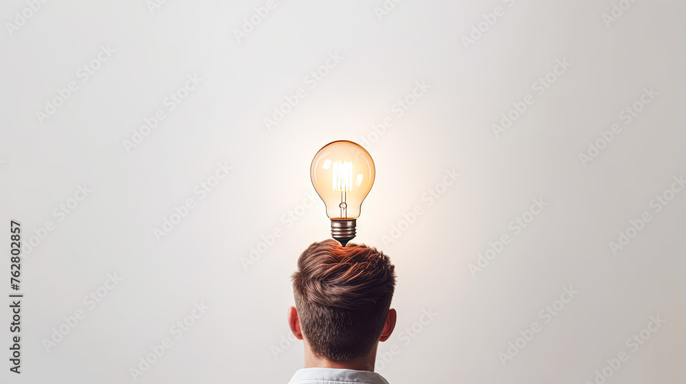 Wall mural A man with a light bulb on his head. The light bulb is lit up and shining brightly. Concept of creativity and innovation, as the light bulb represents an idea or a new concept