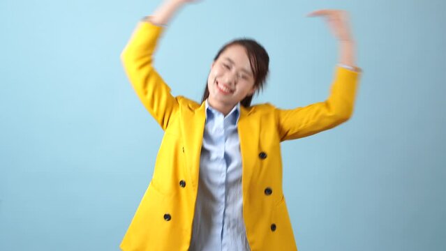 Asian girl making a heart shape with her hands
