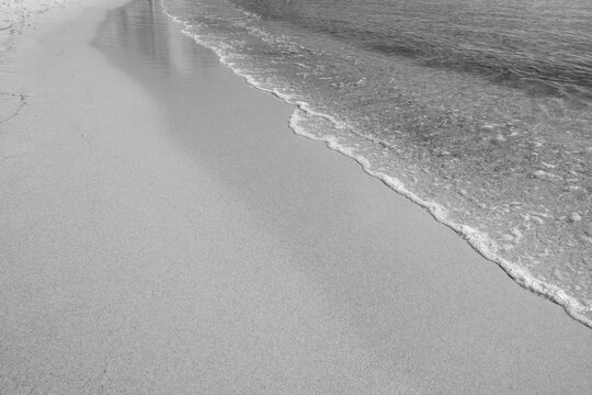 Waves come splashing on the sand beach. High quality photo