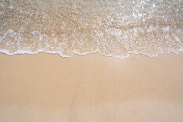 Fototapeta na wymiar Waves come splashing on the sand beach. High quality photo