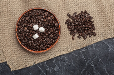freshly roasted coffee beans and sugar in a wooden bowl