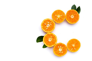 Vitamin C pills with  fresh orange citrus fruit isolated on white background.