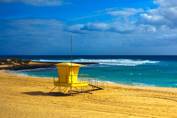 Yellow lifeguard tower on the beach in Fuerteventura, Canary Islands, Spain. Playa El Bajo Begro in...