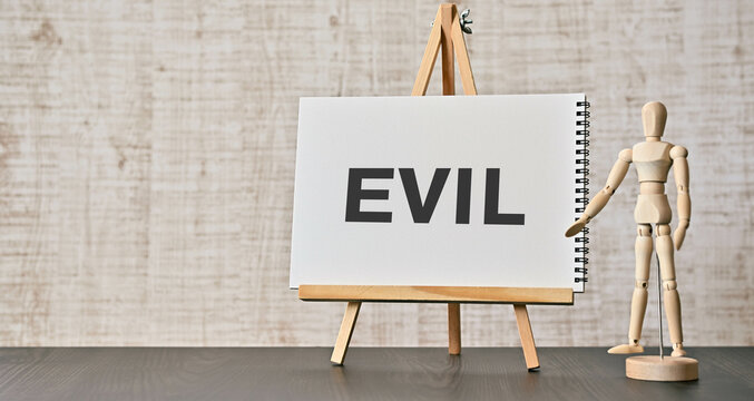 There is notebook with the word EVIL. It is as an eye-catching image.