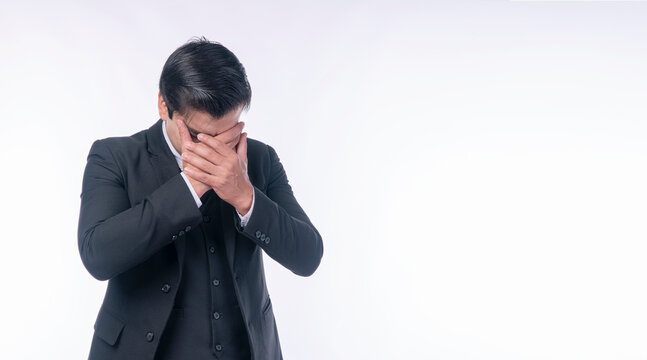 Disappointment unhappy businessman holding hands on head worry problem over isolated white background. Serious tired handsome man suit distressed holding hands on facd sadness. Upset loss guy despair.