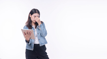 Tired woman wear jean jacket holding hand eye strain with digital tablet trouble reading overworked media online over isolated white background. Unhappy young girl touching eye ache vision problem.
